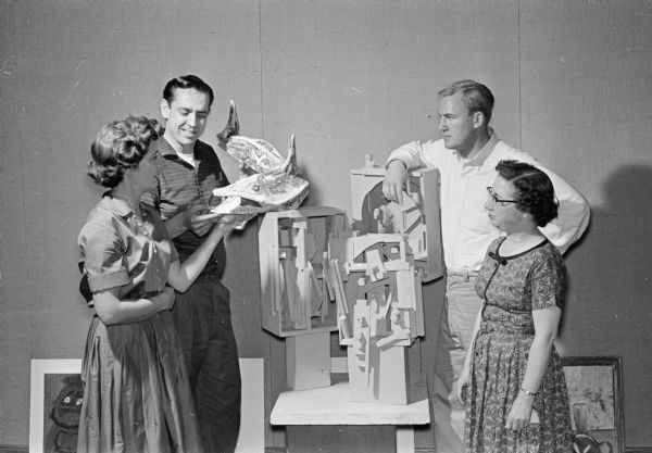 Four teachers examine a sculpture along with the art work of 750 children and teens from Madison's 38 public schools. The 30th annual Salon of School Art was sponsored by the Madison Art Association and held at Central High. Left to right, Betty Lund, Orchard Ridge school; Rollin Jansky, Lowell School; Joe Nyiri, Hawthorn School; and Anona Gilbert, Lapham School and Lincoln School.