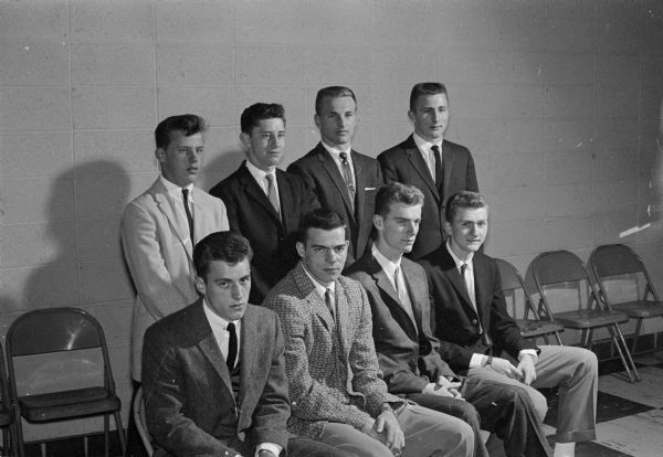 Eight young men wearing suits pose in two rows. Pictured are some of the captains of Monona Grove High School athletic teams honored at their sixth annual athletic banquet.  In front row, left to right, are Toby McCulloch, Sonny Redders, Earl Kielley, football; Clayton Vinje, hockey. In back row, left to right, are Ken Klahn, wrestling; Jim Cass, volleyball; Lloyde Dresen, basketball and baseball; and Jerry Haugh, wrestling.