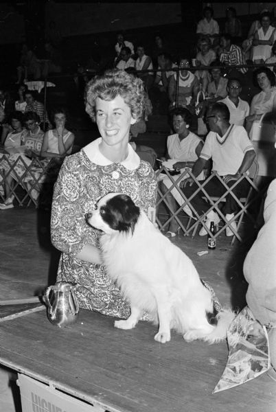 Carol Cowley is shown with her Japanese Spaniel, Sukie Kun, at the Badger Dog Show held at the Dane County fairgrounds. The dog had the highest score in the obedience trial.