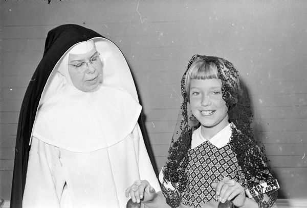 Third grade students at the Edgewood Campus School study Spanish for 20 minutes four days a week. Their teacher is Sister M. Catherine, O.P. Sister Catherine, teacher of conversational Spanish, watches Kathryn Richtsmeier dance to a Spanish song.