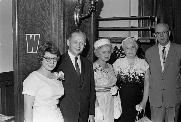 The new Wisconsin Superintendent of Public Instruction Angus B. Rothwell and his first assistant Russell Lewis posing with their wives at the reception following the oath of office for Rothwell. Pictured are Rothwell's daughter, Jean Olson; Rothwell and his wife, Florence; Gertrude and Russell Lewis.