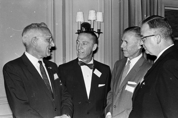 Four participants at the banquet held in connection with the annual seminar of the Economics in Action group at the University of Wisconsin include, left to right, John Wrage, personnel director of Gisholt Machine Company; Thayer Carmichael, economics professor at Pratt Junior College, Pratt, Kansas; L.K. Pollard, personnel director of Ray-O-Vac; and John Shiels, president of Madison Bank and Trust Company and chairman of the State Board of Personnel.
