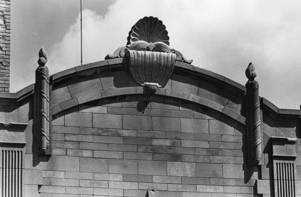 A torch and seashell motif tops the D.P. Zografos Uptown Business and Secretarial Service and Klein's Bakery in 1969 at 320 State Street. The Art Deco abstract classical building designed by Balch & Lippert in 1930, originally belonged to Dr. J.H. Bertrand of DeForest.