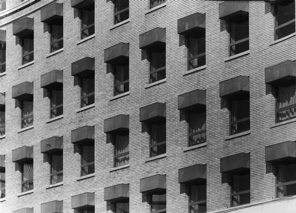 Architectural box motif around air conditioners, created by James Potter, on the Doty Street side of the Beavers Insurance Building, 119 Monona Avenue (Martin Luther King, Jr. Boulevard as of January 19, 1987). This building was originally built for the Beavers Reserve Fund Fraternity (aka National Mutual Benefit, a fraternal life insurance society), in 1922.