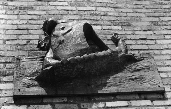 A cast metal plaque of a Viking ship over the entrance to the Norway Center at 2262 Winnebago Street, which officially opened on June 15, 1963. The plaque is a variation of the insignia of the Sons of Norway.