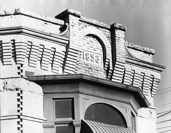 Exterior of the top story of the Gilman Press Building, built in 1893, at the corner of 301 North Hamilton and East Johnson Streets. This building housed a succession of grocery stores and is currently the location of the Pinkus McBride convenience store.