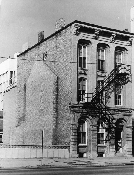 Exterior view of the GAR (Grand Army of the Republic) Memorial Hall, 118 Monona Avenue, (Martin Luther King, Jr. Boulevard as of January 19, 1987). The building belonged to the Soldiers Memorial Association, which was incorporated in 1902 for the purpose of "purchase, erection, maintenance, and furnishing of a building for the use of certain patriotic societies.". The sign above the entrance reads: "Dane County GAR Memorial Hall."