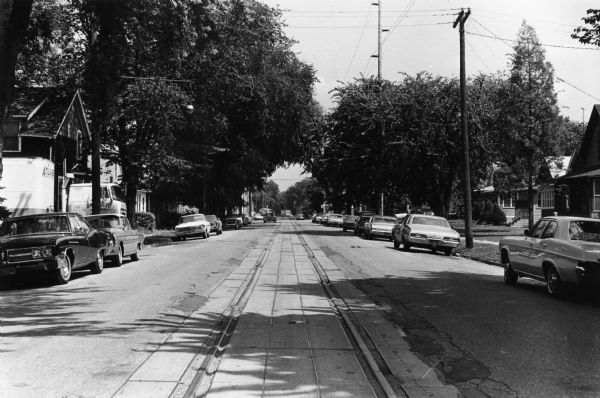 Chicago, Milwaukee, St. Paul & Pacific Railroad tracks running down the middle of East Wilson Street from South Baldwin Street to Dickinson Street.