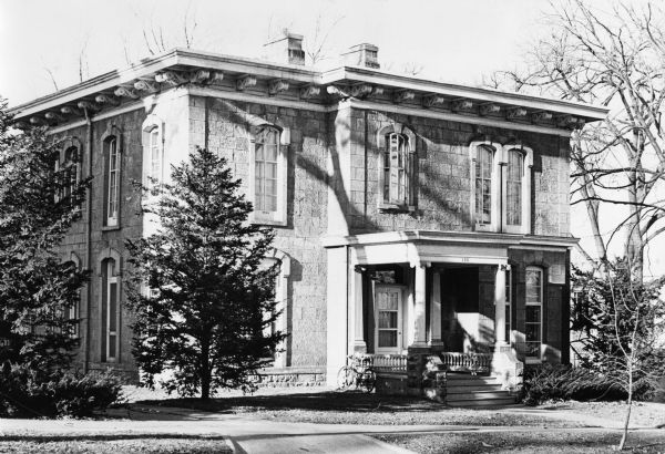 First Wisconsin Governor's Mansion, which served as the home for seventeen governors from 1883 to 1950, 130 East Gilman Street. It is often called the "executive residence," as suggested by Belle Case La Follette. The inside features high ceilings, arched doorways, narrow fireplaces and a winding staircase.