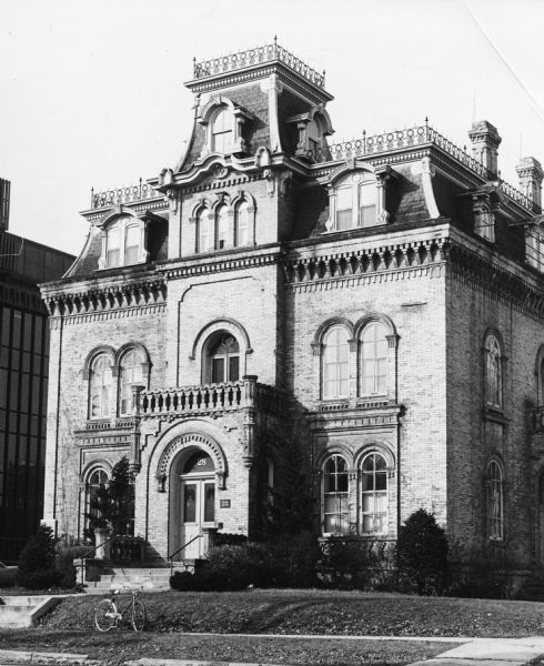Exterior view of German Romanesque revival brick house built in 1857 with a Second Empire-style mansard roof added in 1870, 28 East Gilman Street in the Mansion Hill neighborhood.  Designed by August Kutzbock for Napoleon Bonaparte Van Slyke who never lived there.  Dr. George Keenan, a prominent Madison physician and United States consul to Kiel and Bremen, Germany, and his wife, Mary, lived in the house from 1900 to 1916.