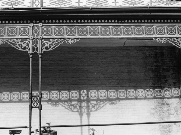 Detail of ornamental iron lattice-work on German Romanesque revival McDonnell/Pierce House, 215 North Pinckney Street. Built in 1857-58 for Alexander and Francie McDonnell.  It was designed by Samuel Donnel and August Kutzbock.  George and Carrie Pierce used it as their residence and boarding house from 1906 to 1938.  It is now the Mansion Hill Inn Bed and Breakfast.