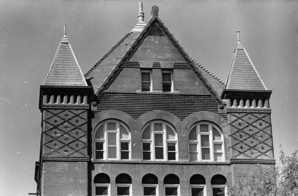 Upper portion of old Science Hall on the University of Wisconsin-Madison campus. The building has bright red brickwork and a gingerbread house design and was one of the first in the country with steel truss underpinnings.