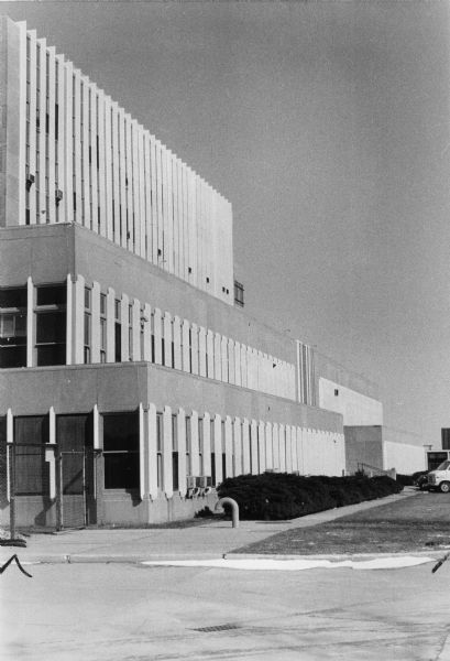 Exterior view of the facade of Forest Products Laboratory featuring white slatted window trimmings. The laboratory, maintained by the Forest Service of the U.S. Department of Agriculture, has been the country's center for wood research since the main building was built in 1932.