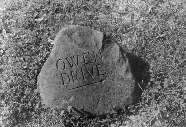 Owen Drive stone street marker placed across from Holy Cross Cemetery at Highland and Regent Streets.