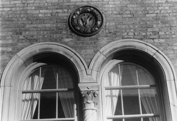 A circular detail above a double window on the exterior of the Gamma Phi Beta sorority house at 270 Langdon Street.