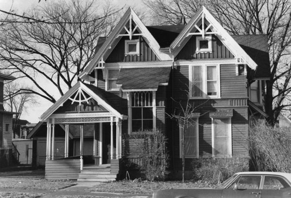 Judson C. Cutter house, 1030 Jenifer Street, built in 1884. The house was built with influences of American Stick Style architecture with lateral clap boards accenting the building's frame, gothic architecture in the cathedral style upper portion of the front window, and the Elizabethan Jacobean posts and spindles on the front porch and awning in place of more typical pillars.
