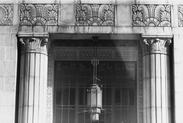Exterior view of the entrance to the State Office Building at 1 West Wilson Street with decorative columns and carving.