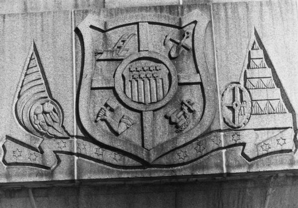 A relief of a partial State Seal design over the Wilson Street  entrance of the State Office Building's east wing.