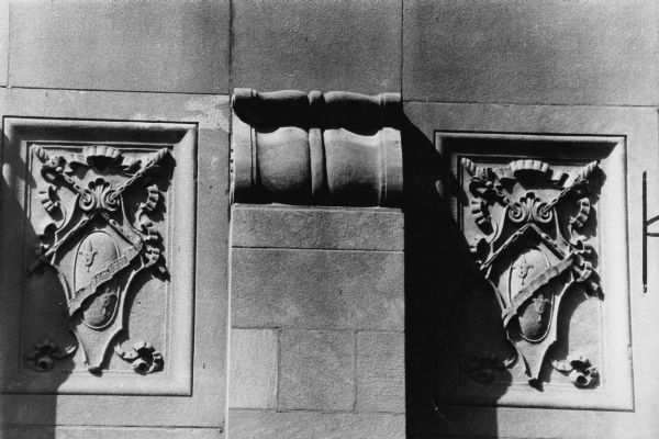 Two coats of arms which are carved into the building face of the Orpheum Theatre at 216 State Street above the marquee.