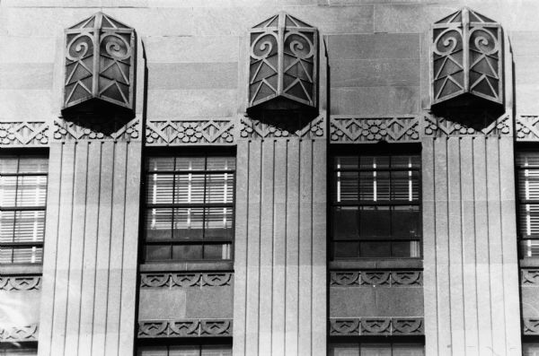 Roof-edge lights on the Tenney Building at 110 East Main Street. The lights and building reflect an Art Deco design.