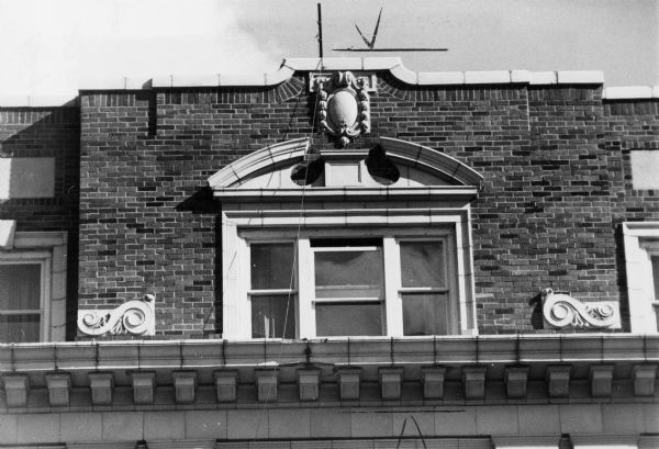 A "broken" pediment over a window on a Madison building. This style is typical of pediments developed in the baroque period.