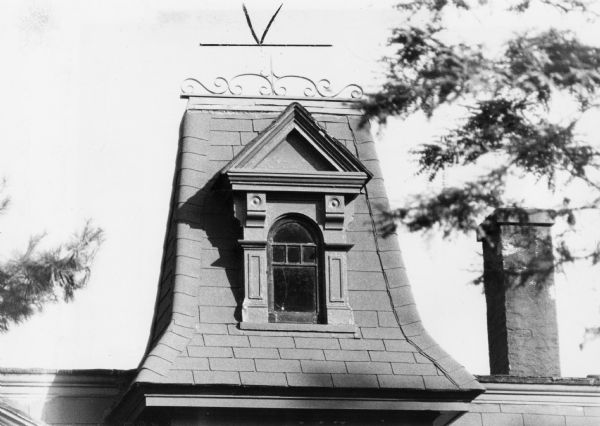 A peculiar mini-rooftop featuring a classical triangular pediment on a house at 124 North Baldwin Street.