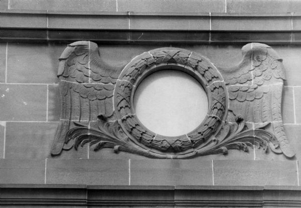 A wing design, possibly carved in stone, above the entrance of the building at 149 South Blair Street. The building was originally the North Western Railroad depot and now houses Madison Gas and Electric offices.