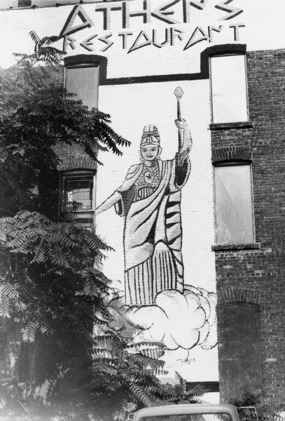 Three-story tall painting of Athena, the Greek goddess of wisdom and war, that decorates the rear wall of a State Street restaurant.