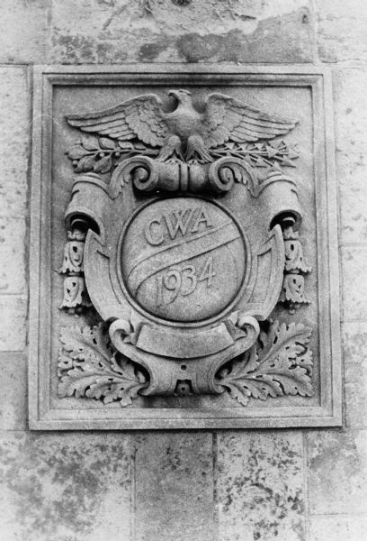 Civil Works Administration emblem on the stone wall of Breese Stevens Field at the corner of East Washington Avenue and Paterson Street.