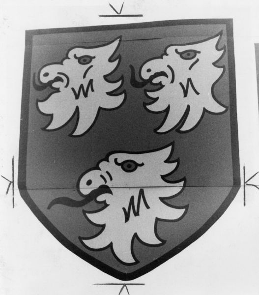 A coat of arms depicting three animal heads (demons? eagles?), used by Ryan Cars, Inc. at 1136 East Washington Avenue.
