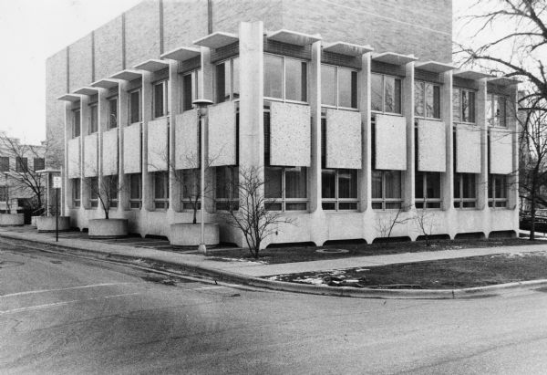 Exterior view of the University of Wisconsin Primate Center at 1220 Capitol Court. This functionalist style features stone awnings and separated stone panels.