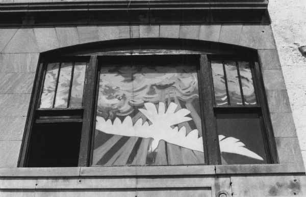 A window painted with religious symbols, including a dove (the Holy Ghost), in the Upper Room Fellowship coffee house at 420 State Street.