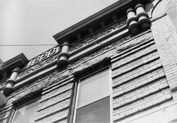 Decorative "1893" relief on the exterior of a building at 430 State Street, indicating the date the building was built. Brackets are shown alongside the relief supporting a decorative frieze.