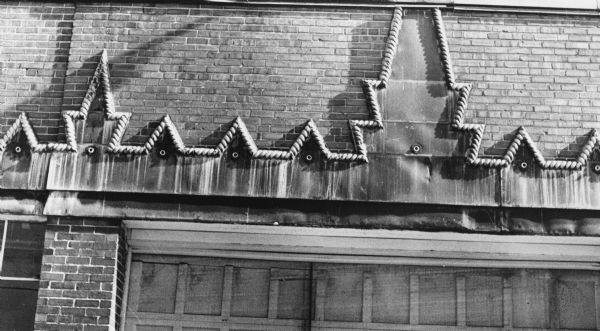 A Romanesque cable moulding decorating the face of the F. W. Means Towel Service, a laundry at 1910 Winnebago Street.  Building was used by Klinke Hatchery 1932-1936.  Historically, mouldings were so precise that an approximate date of a building could be determined from them.