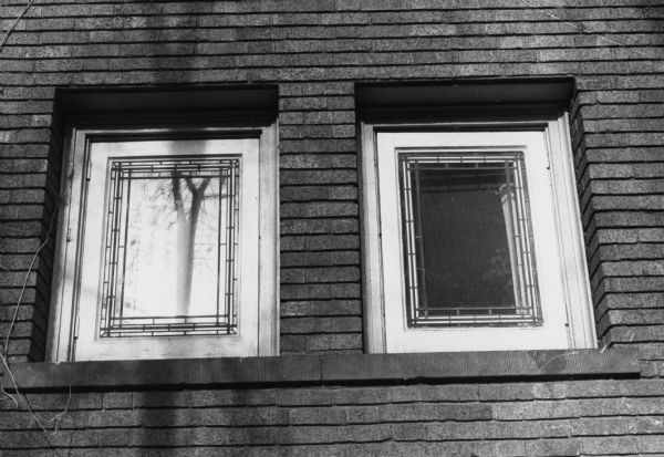 Windows on a building at 514 North Carroll Street displaying a casement style. The leaded features holding together the strips of glass at the edges are called "quarrels".