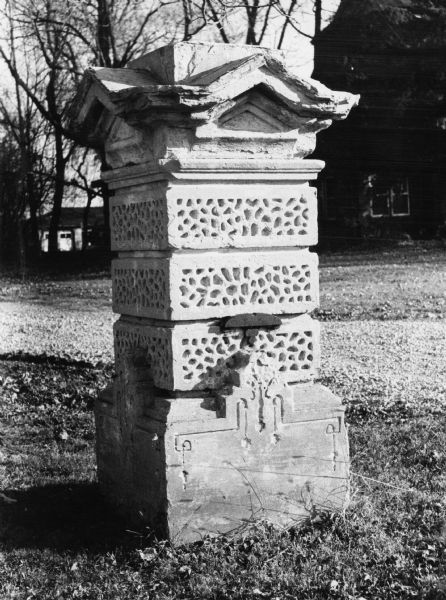 A five-foot tall pillar which used to be part of one of the gateposts linked by an iron fence that surrounded the Wisconsin State Capitol grounds. In 1976 the pillar stood at the driveway entrance to a house at 2833 Fish Hatchery Road. Two similar pillars are on the grounds of Mendota Mental Health Institute.