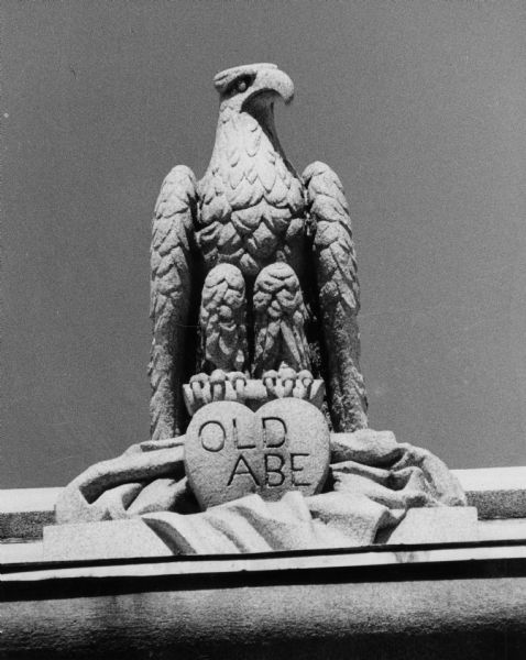 A stone sculpture of the eagle Old Abe, mascot of the Civil War Eighth Wisconsin Infantry. The stylized sculpture of an eagle features "Old Abe" carved in a heart at its feet and is at the top of the Camp Randall Arch near Camp Randall Stadium.