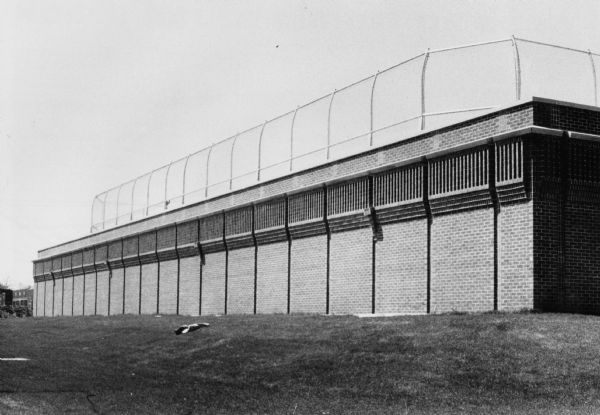 Exterior view of a tennis court situated on top of the Madison Water Utility pumping station at Reynolds Park, which is on Livingston Street between East Dayton and East Mifflin Streets.