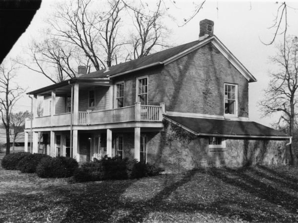 Exterior view of the Keystone House, 901 University Bay Drive, which was built of stone and timber in 1853 by Squire William Pethrick. The Wisconsin Alumni Research Foundation bought it in 1967 and donated it to the University of Wisconsin-Madison. It is the home of the Max Kade Institute for German American Affairs.