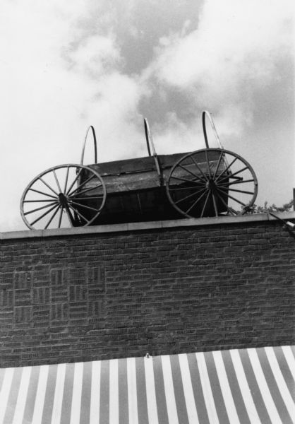 A covered wagon placed on the roof of the Red Shed Bar at 406 North Frances Street.