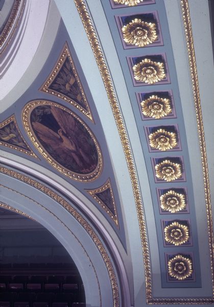 Detail of ceiling in Assembly Room of the Wisconsin State Capitol. Includes paintings of an eagle and decorative plasterwork.