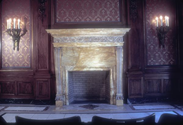 Assembly Parlor fireplace in the Wisconsin State Capitol. The walls are of walnut panelling, the mantels are Sienna marble, and the floor is marble tile.