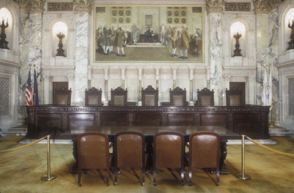 The Supreme Court, before restoration, in the Wisconsin State Capitol. The painting, "The Signing of the American Constitution," is by Albert Herter, and is one of four paintings in the room.