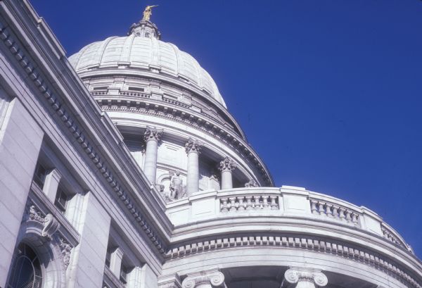 Exterior of the Wisconsin State Capitol, including the "Wisconsin" statue on top of the dome.