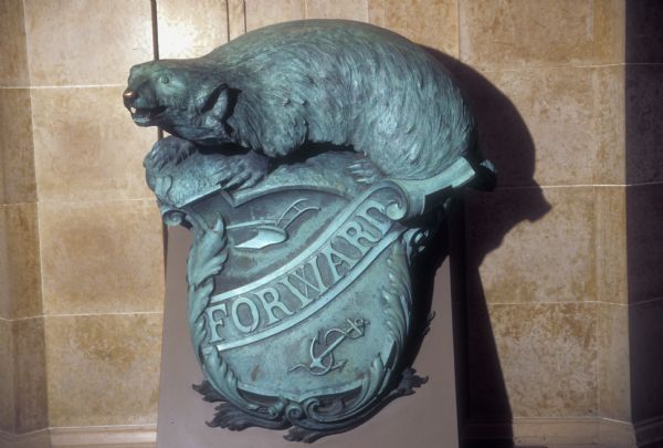USS "Wisconsin" Badger in front of the Governor's Conference Room at the Wisconsin State Capitol. This figure, with the state motto "Forward," was sculpted in 1900 and served through World War I and World War II on the Battleship "Wisconsin." It is on permanent loan from the Navy and the State of Wisconsin.