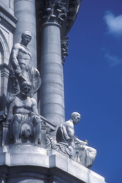 One of four allegorical statuary groups, done by sculptor Karl Bitter, on the exterior of the Wisconsin State Capitol. This one is named "Strength," and is above the fourth floor facing West Washington Avenue. Each of the four statuary groups around the dome consist of three figures.