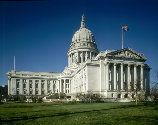 Exterior of the Wisconsin State Capitol, with view of the grounds, staircases, and two of the four wings.