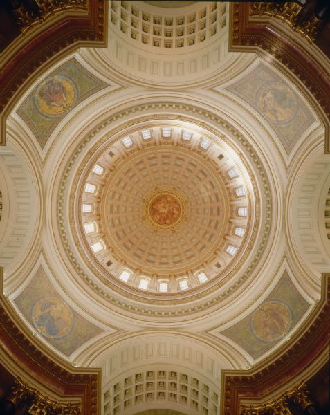 Interior view of dome with four pendentives, arches, and the painting, "Resources of Wisconsin," in the Wisconsin State Capitol.