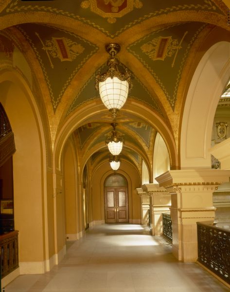 Interior corridor of the Wisconsin State Capitol, with arches and lanterns.