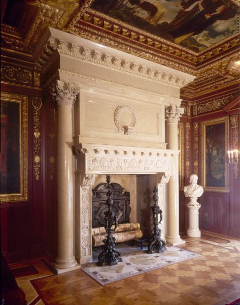 The Governor's Conference Room fireplace, in the Wisconsin State Capitol. The fireplace is hand-carved of Italian Botticino marble. It is flanked on each side by a Corinthian column. There are two bronze andirons.